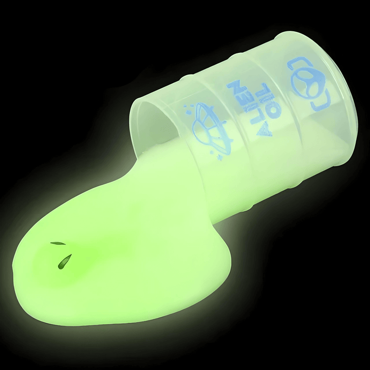 Glow in the dark 2.25" alien slime spilling from an oil barrel toy, perfect for kids' fun and fidgeting.