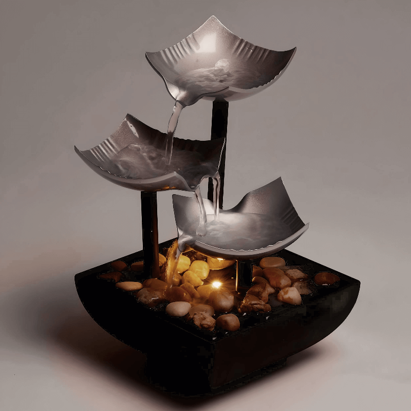 3-tier black and silver table fountain with LED light and stone decor, creating a calming ambiance.