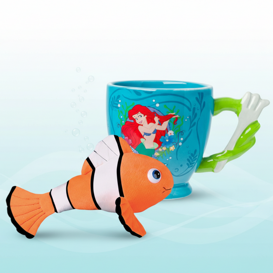 Mug with a cartoon design of a mermaid and fish on a light blue background