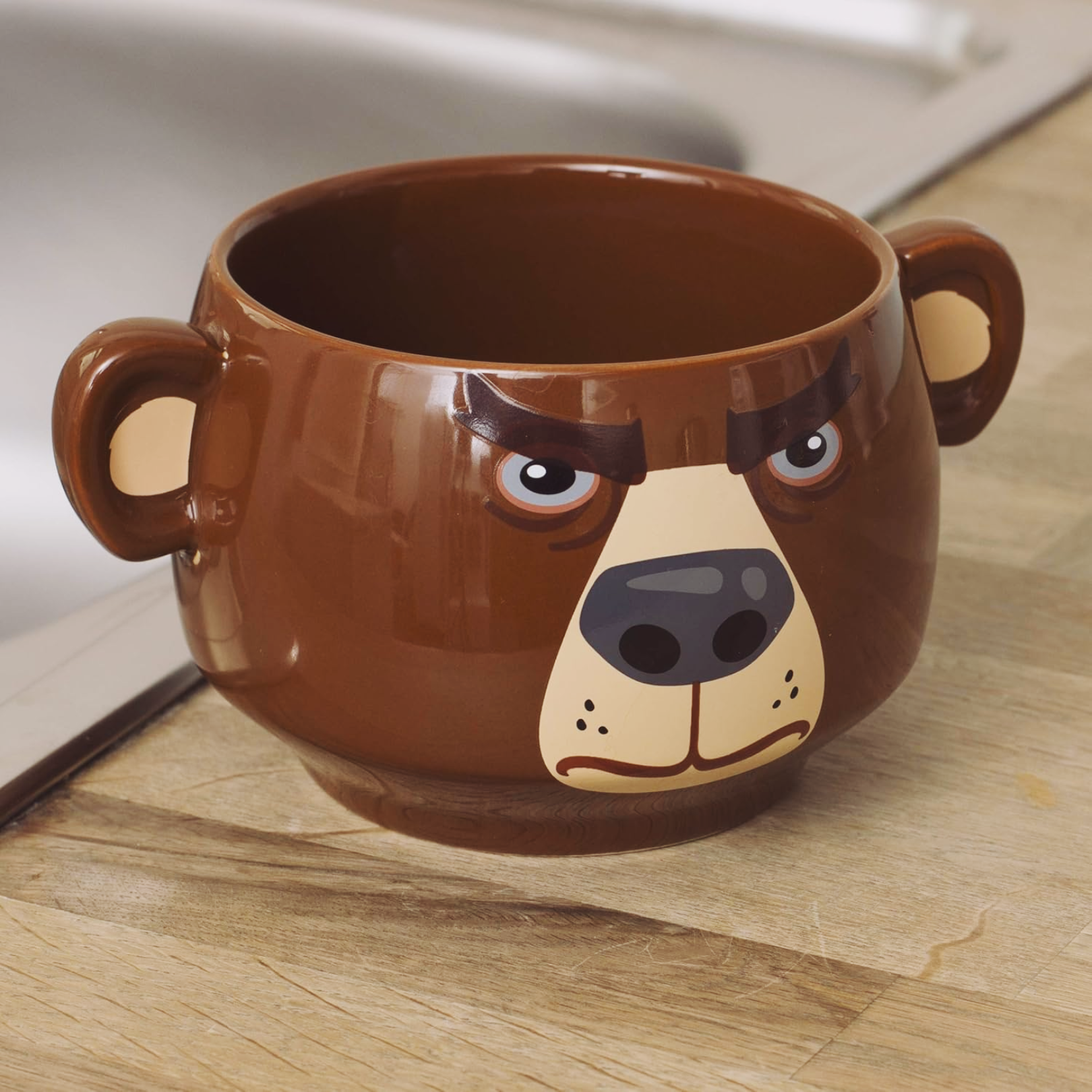 Bear Heat Change Mug featuring a frowning bear face design, perfect for beverage enjoyment.