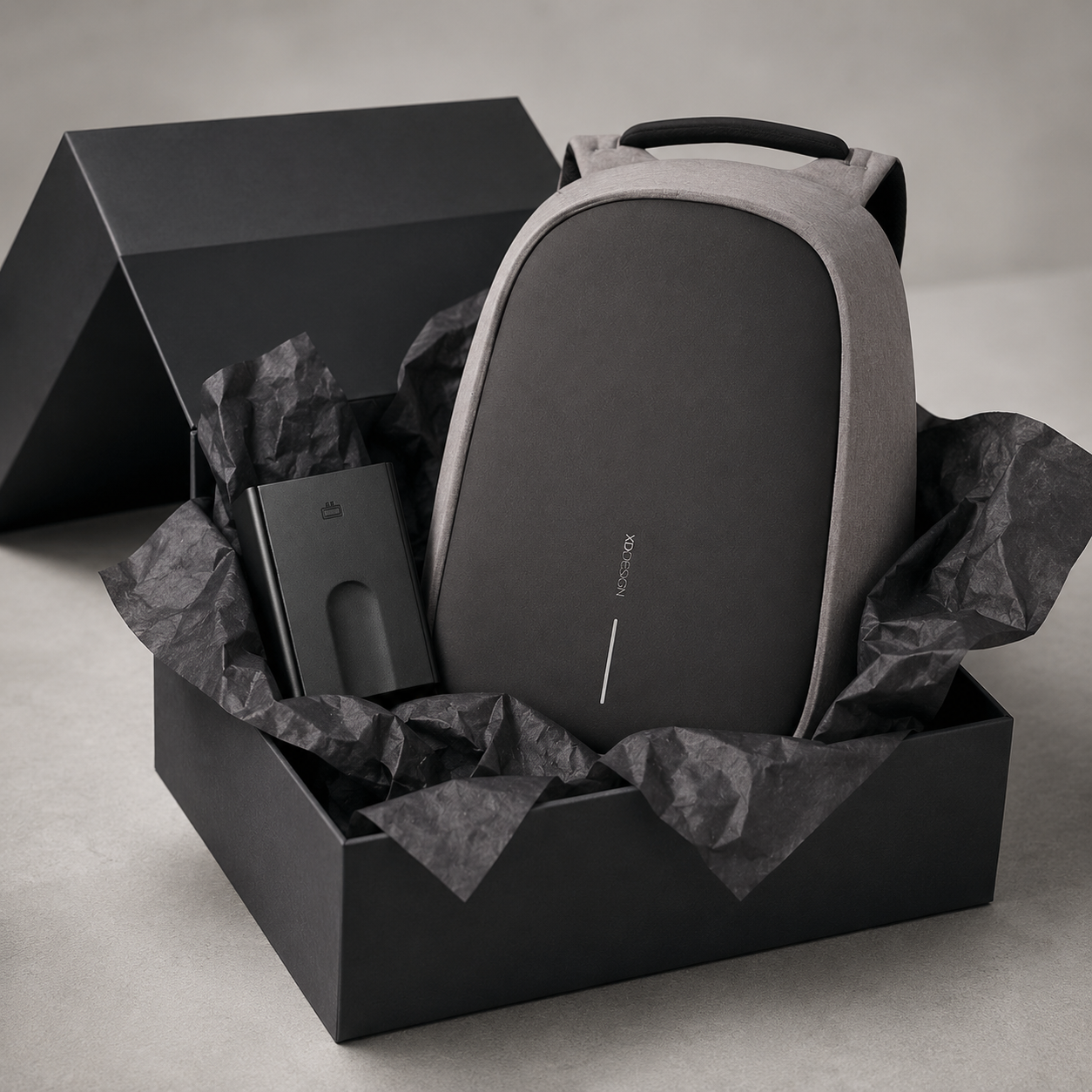 Anti-Theft Backpack and Aluminum Wallet Set in a stylish gift box with crumpled paper.