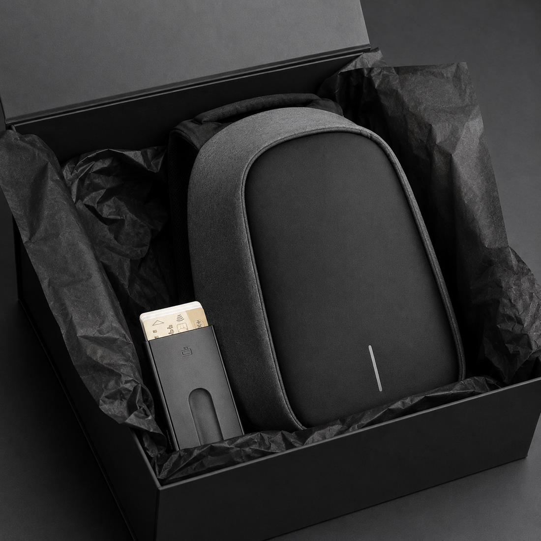 Anti-Theft Backpack and Aluminum Wallet Set in a gift box with tissue paper.
