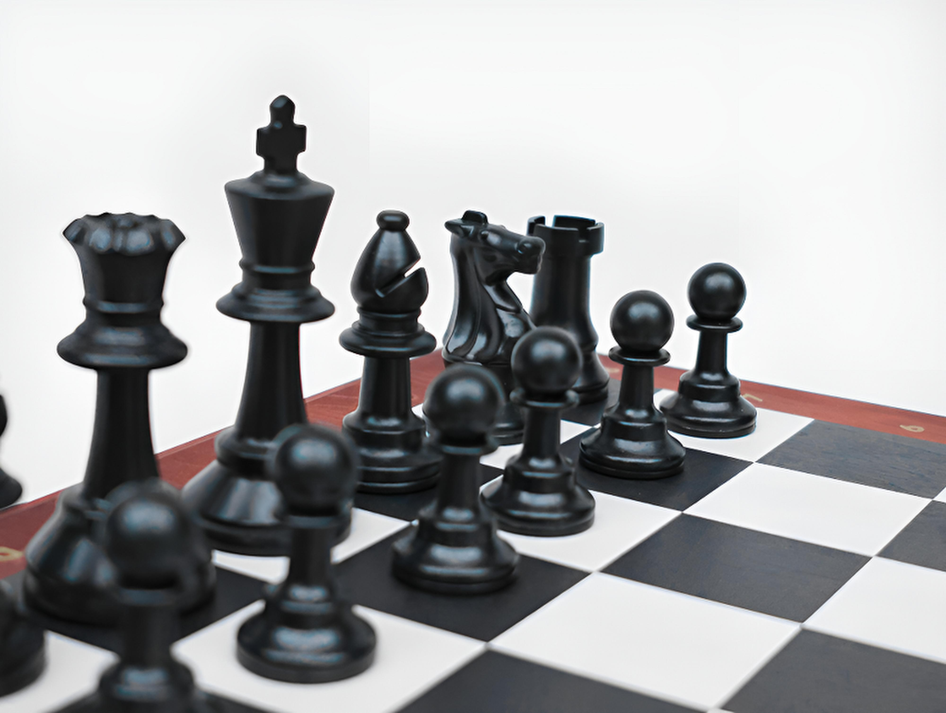 Chess Deluxe - premium wooden chess set featuring full-size black resin pieces on a classic checkerboard.