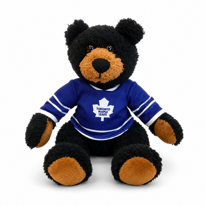 Plush bear wearing a Toronto Maple Leafs jersey on a white background