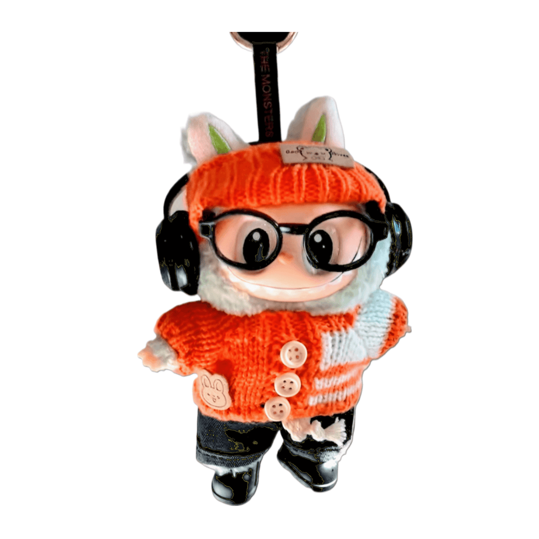 Energetic Orange Monster Buddy Doll wearing orange sweater, glasses, and headphones, 17 cm tall.