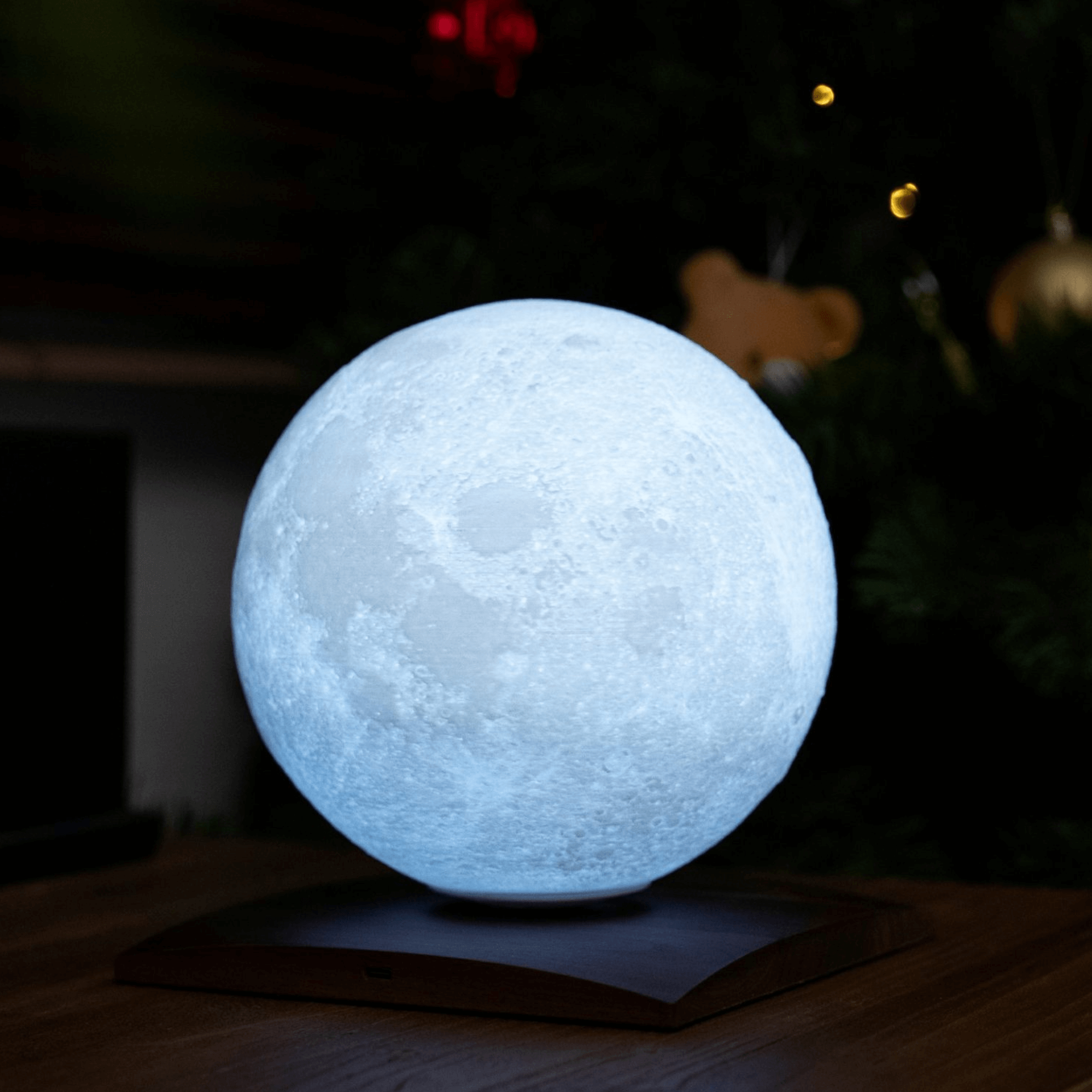 LunaSpin Mini Lamp featuring a rotating 3D moon light on a wooden base, perfect for illuminating small spaces.