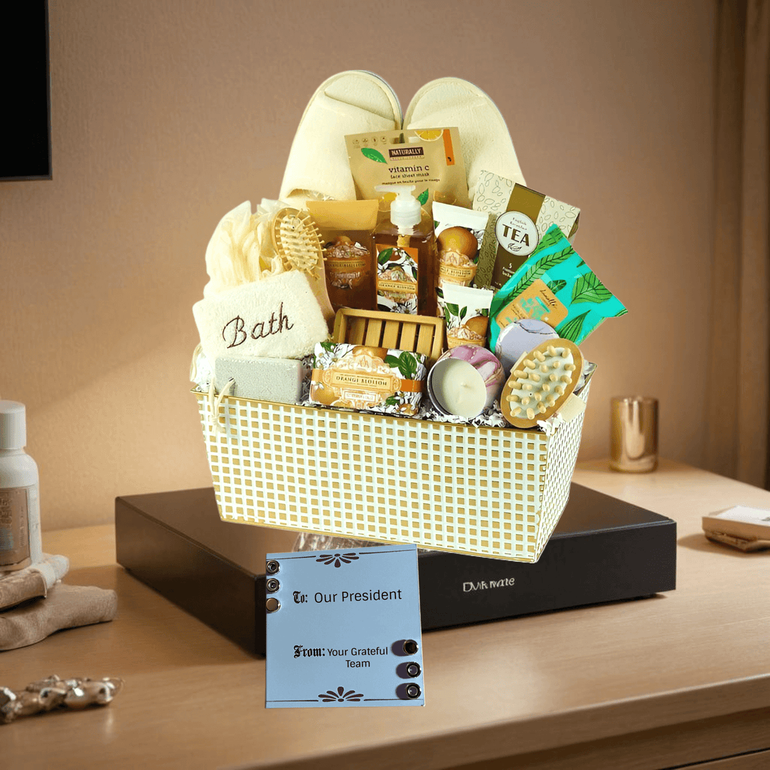 Spa Dreams Gift Basket filled with bath essentials, tea, and self-care items on a tabletop with a gift note.