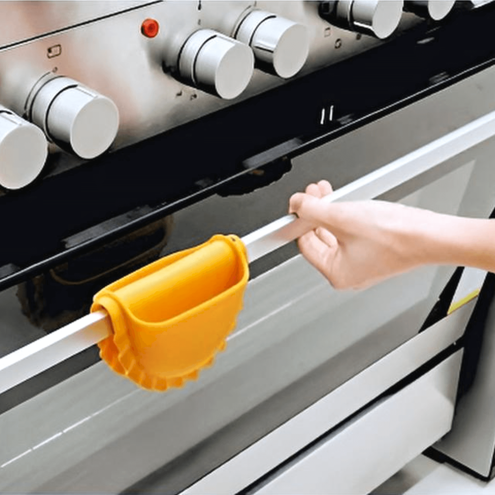 Person using Mezzelune Silicone Oven Mitt to safely handle hot oven door.