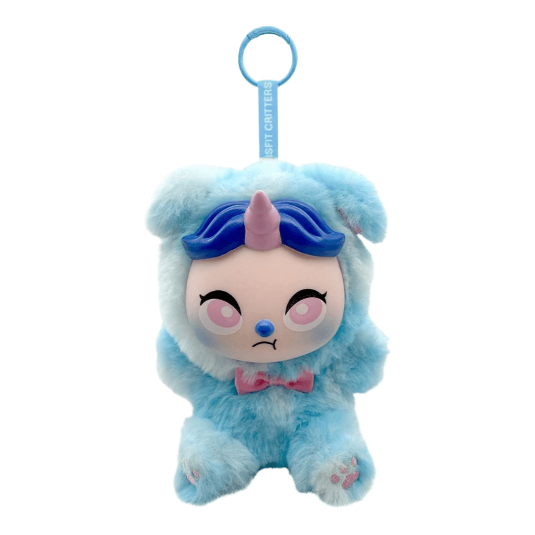 A light blue plush character keychain with a pink horn, blue hair, and a pink bow tie, featuring a blue hanging loop with the text 'SOFT GARTER'.