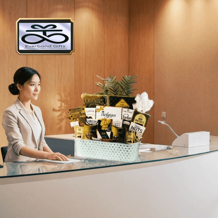 Bucketful of Gourmet – Deluxe Savoury & Sweet Basket displayed at a reception desk with a professional smiling.