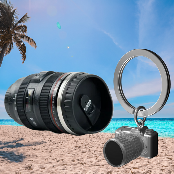 Camera lens and keychain on a beach with palm tree and blue sky
