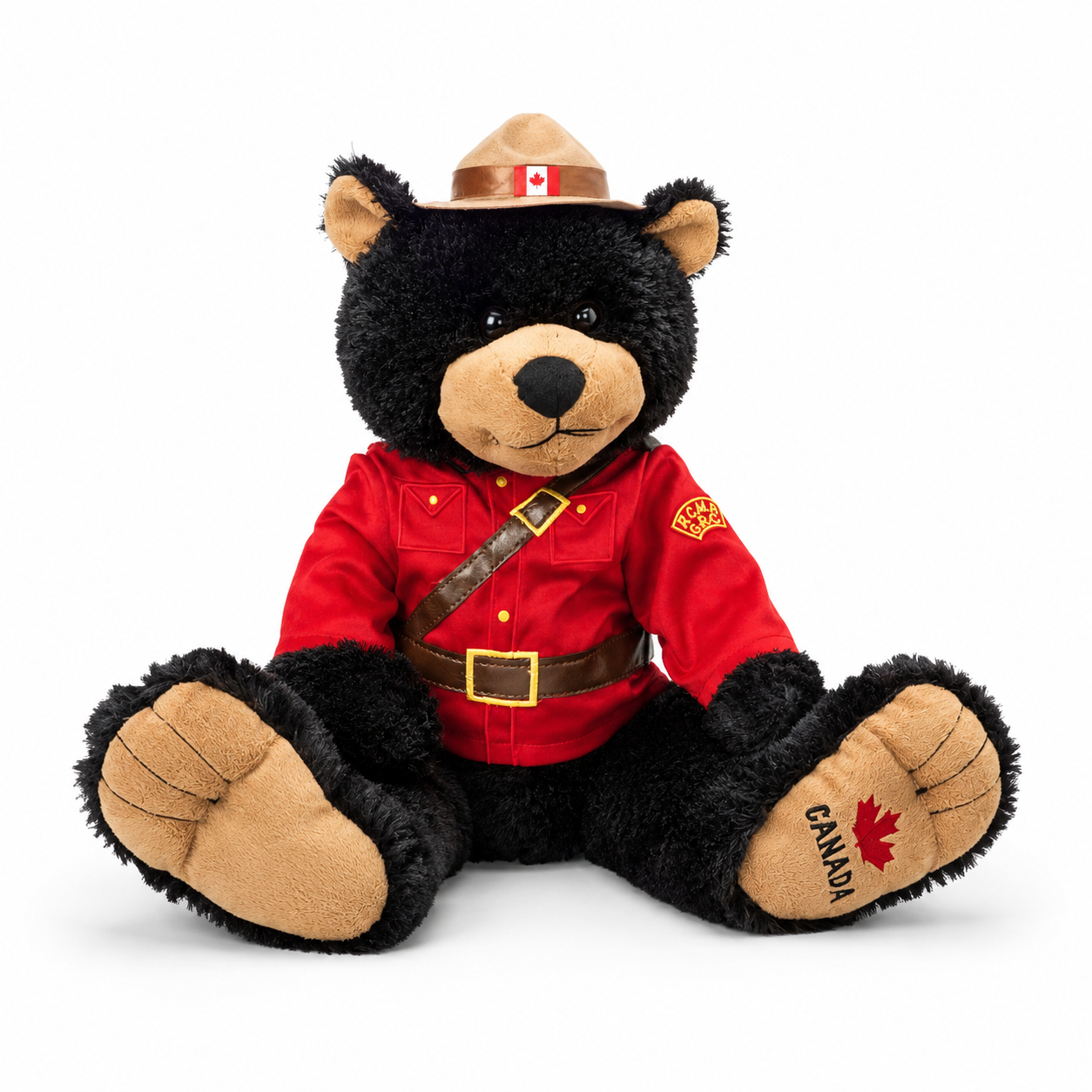 Plush bear toy in RCMP uniform with red jacket, tan hat, and 'Canada' on paw on white background