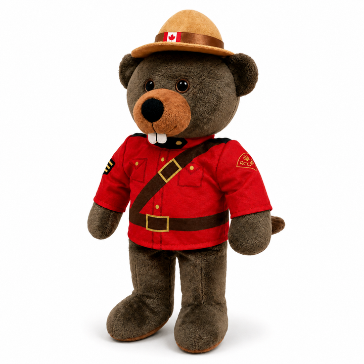 Stuffed bear toy in RCMP uniform with red jacket and brown hat on a white background