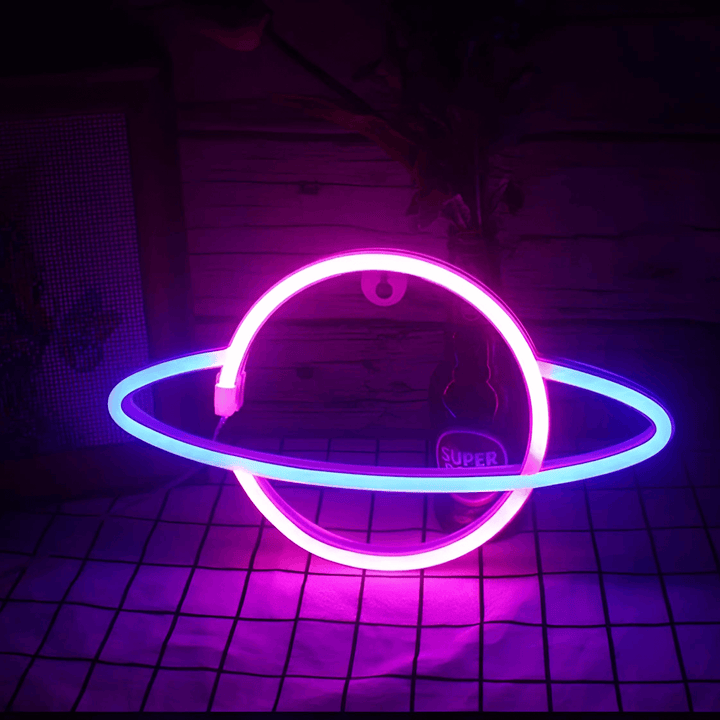 Saturn Neon Wall Light - Led Sign illuminating a space with pink and blue glow, adding modern ambiance to any room.