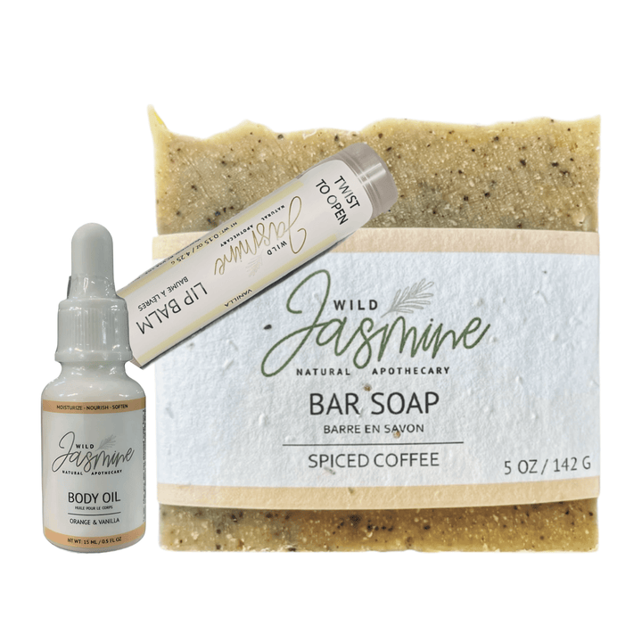 Bar of soap, lip balm, and body oil with 'Wild Jasmine' branding on a white background
