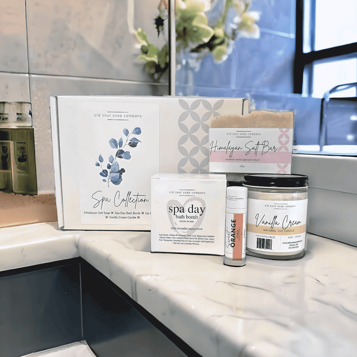 Handcrafted Canadian Spa Collection gift set featuring bath bomb and vanilla cream on a marble countertop.