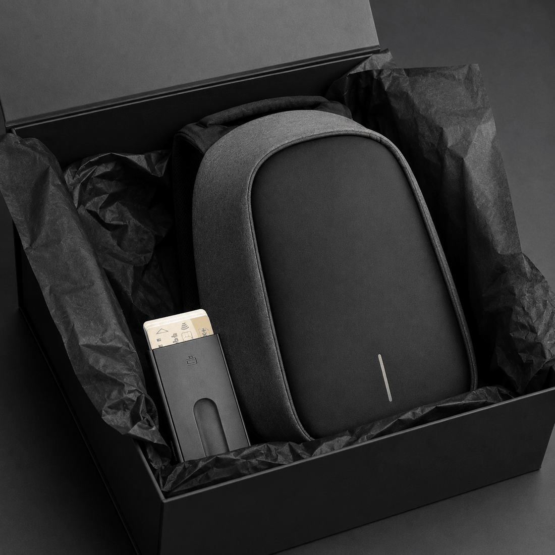Anti-Theft Backpack and Aluminum Wallet Set in a gift box with tissue paper.