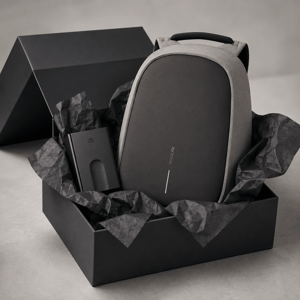 Anti-Theft Backpack and Aluminum Wallet Set in a stylish gift box with crumpled paper.