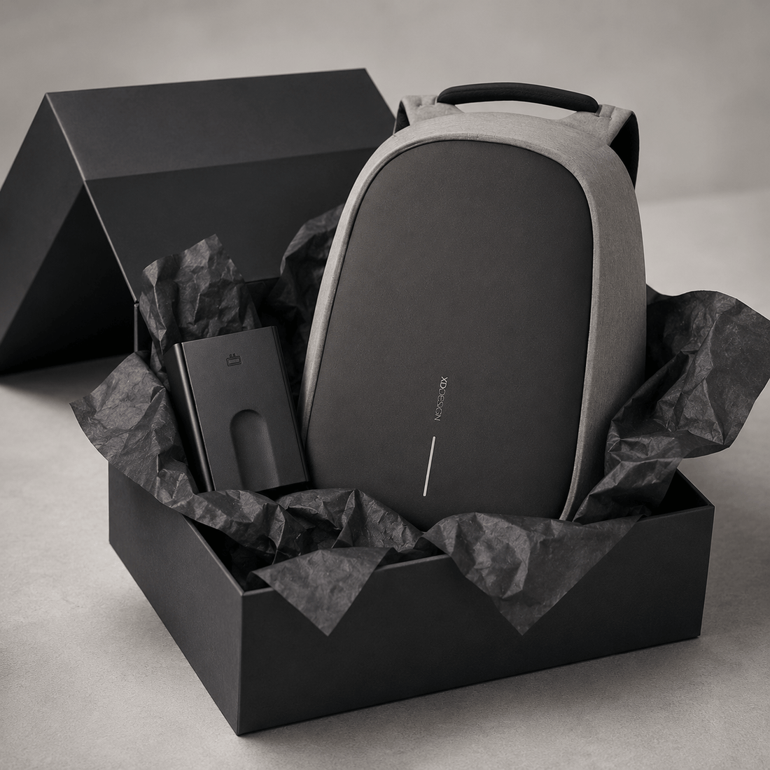 Anti-Theft Backpack and Aluminum Wallet Set in a stylish gift box with crumpled paper.