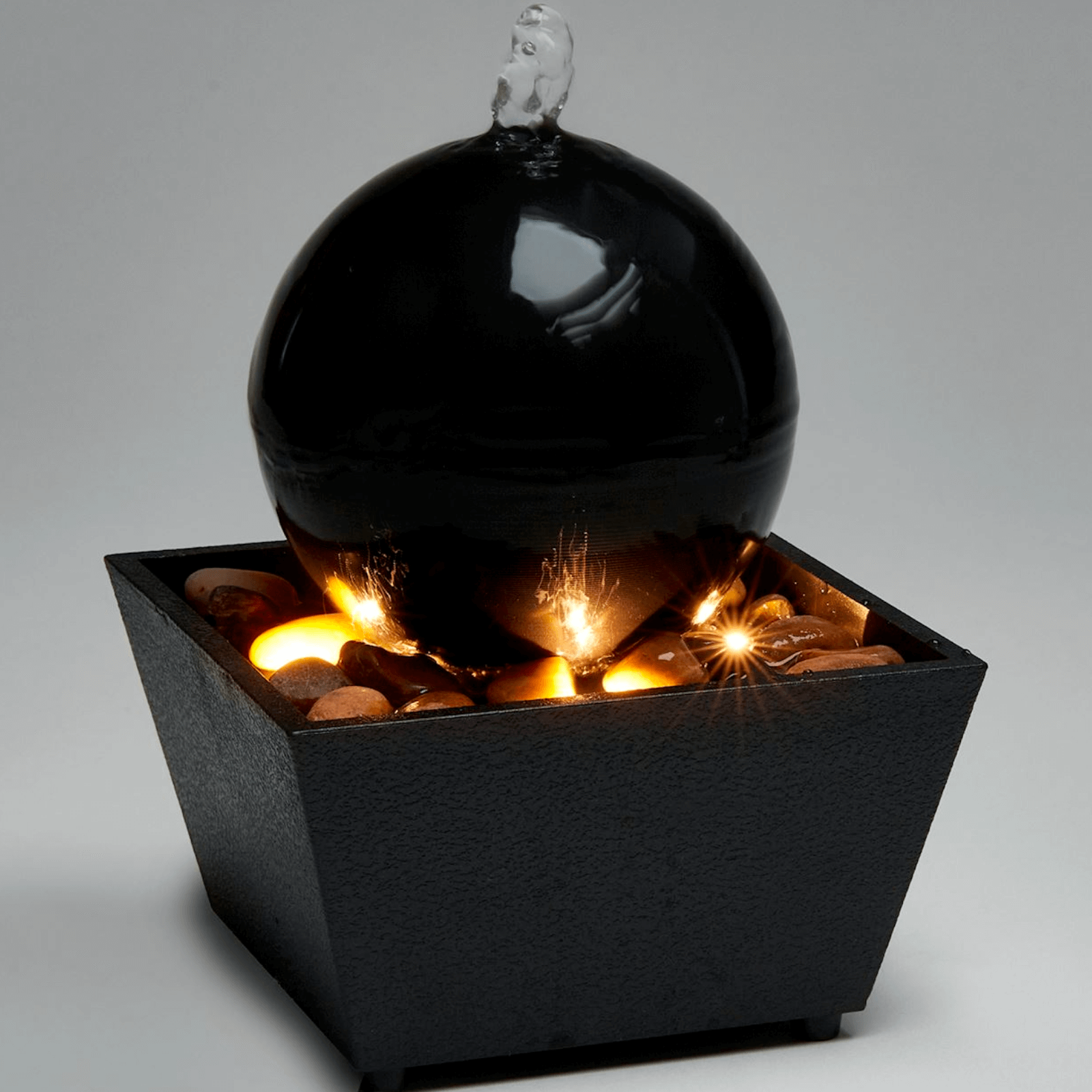 Ball table fountain with LED light, elegant design and soothing water flow for indoor decor.