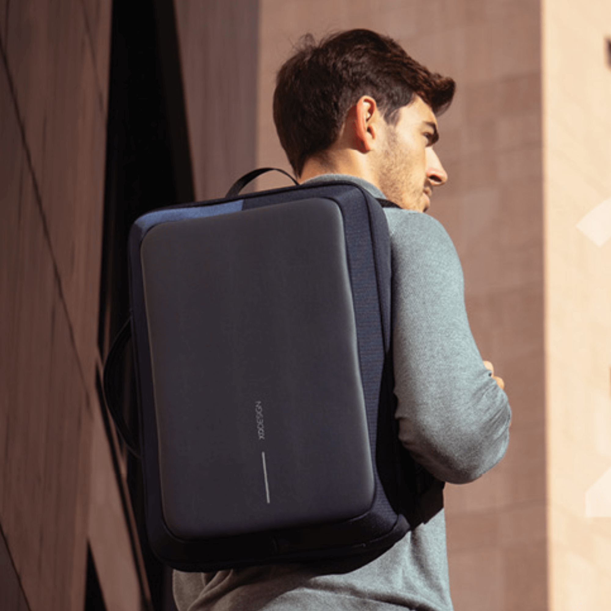 Man wearing Bobby Bizz 2.0 Anti-Theft Backpack in urban setting with sleek, professional design.