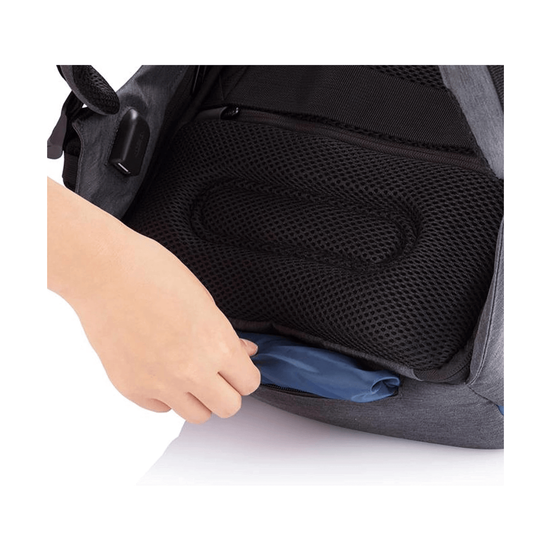 Person using the pocket of the Bobby Compact-Diver Blue backpack for storage.