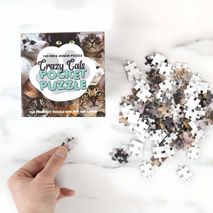 Pocket Puzzles - Crazy Cats mini jigsaw puzzle with pieces on a table, perfect for cat lovers.
