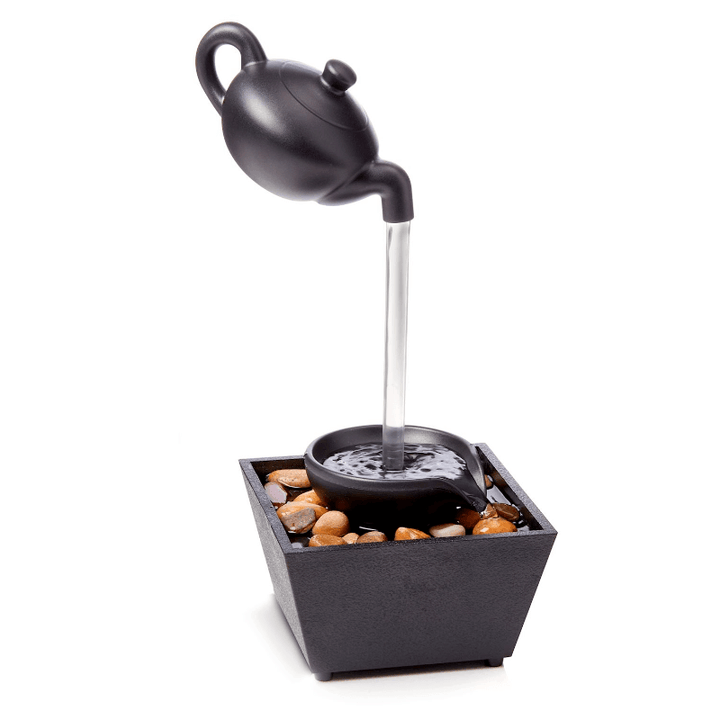 Floating teapot table fountain with LED light, showcasing gentle water flow and soothing ambiance.