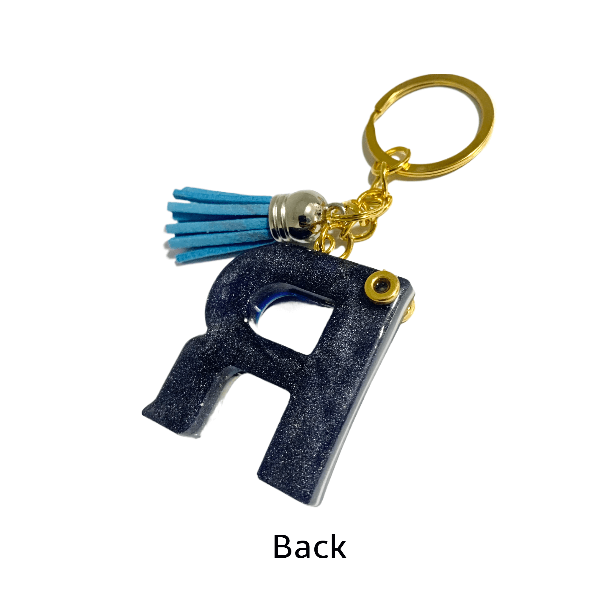 Back view of Keychain - Letter R with blue tassel and gold hardware, showcasing elegant design and craftsmanship.