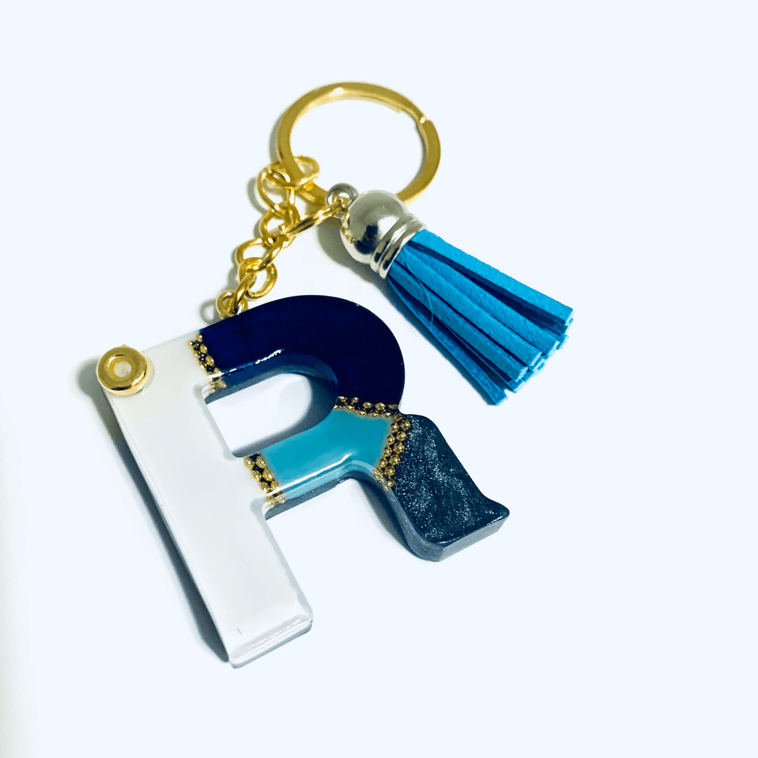 Keychain - Letter R featuring white and blue marbled design with a blue tassel and gold accents.