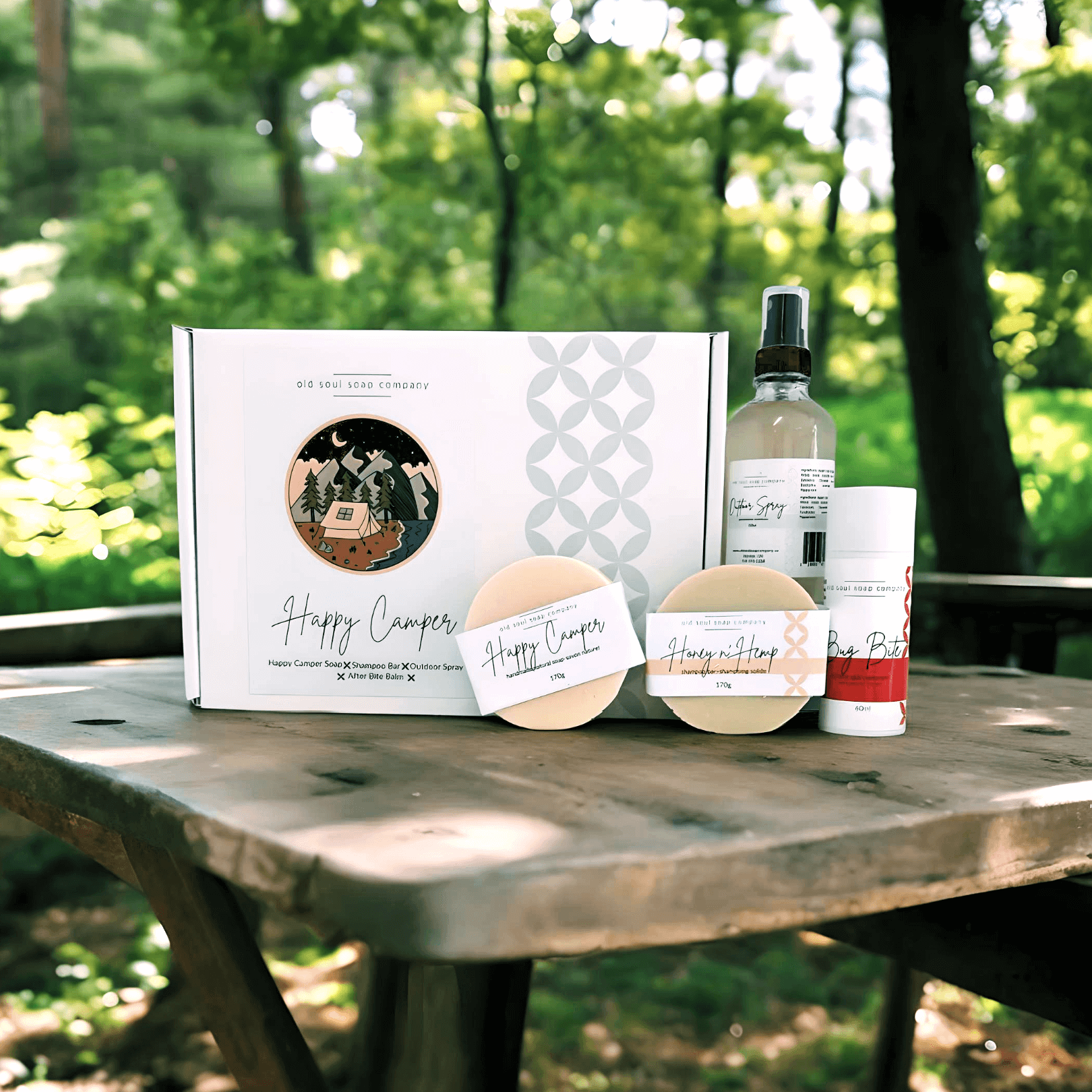 Happy Camper Collection featuring handmade natural outdoor essentials by Old Soul Soap Company on a wooden table.