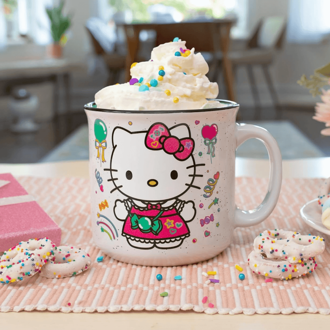 Hello Kitty Jumbo Camper Mug decorated with birthday elements, filled with whipped cream and colorful sprinkles.