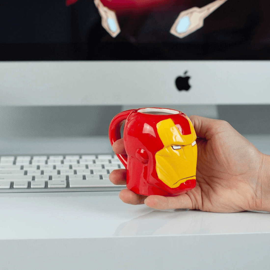 Iron Man Mini Mug in hand, featuring vibrant Tony Stark armor design, perfect for espresso or tea.