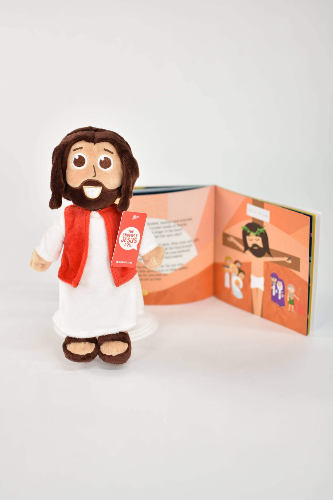 Plush Jesus doll with a book, ideal for kids' faith-based storytelling and snuggling.