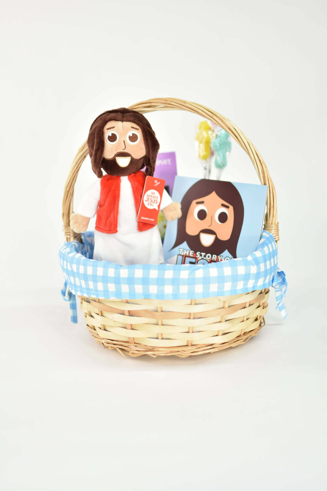 Jesus doll and Bible story books in a gift basket, perfect for children.