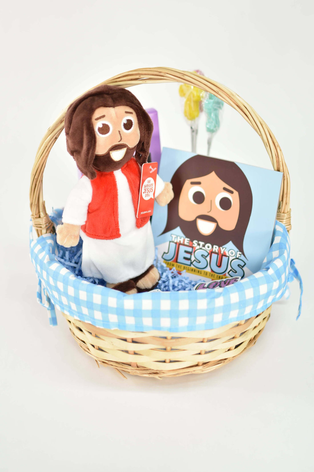 Plush Jesus doll and Bible storybook bundled in a decorative basket, perfect for kids' gifts.
