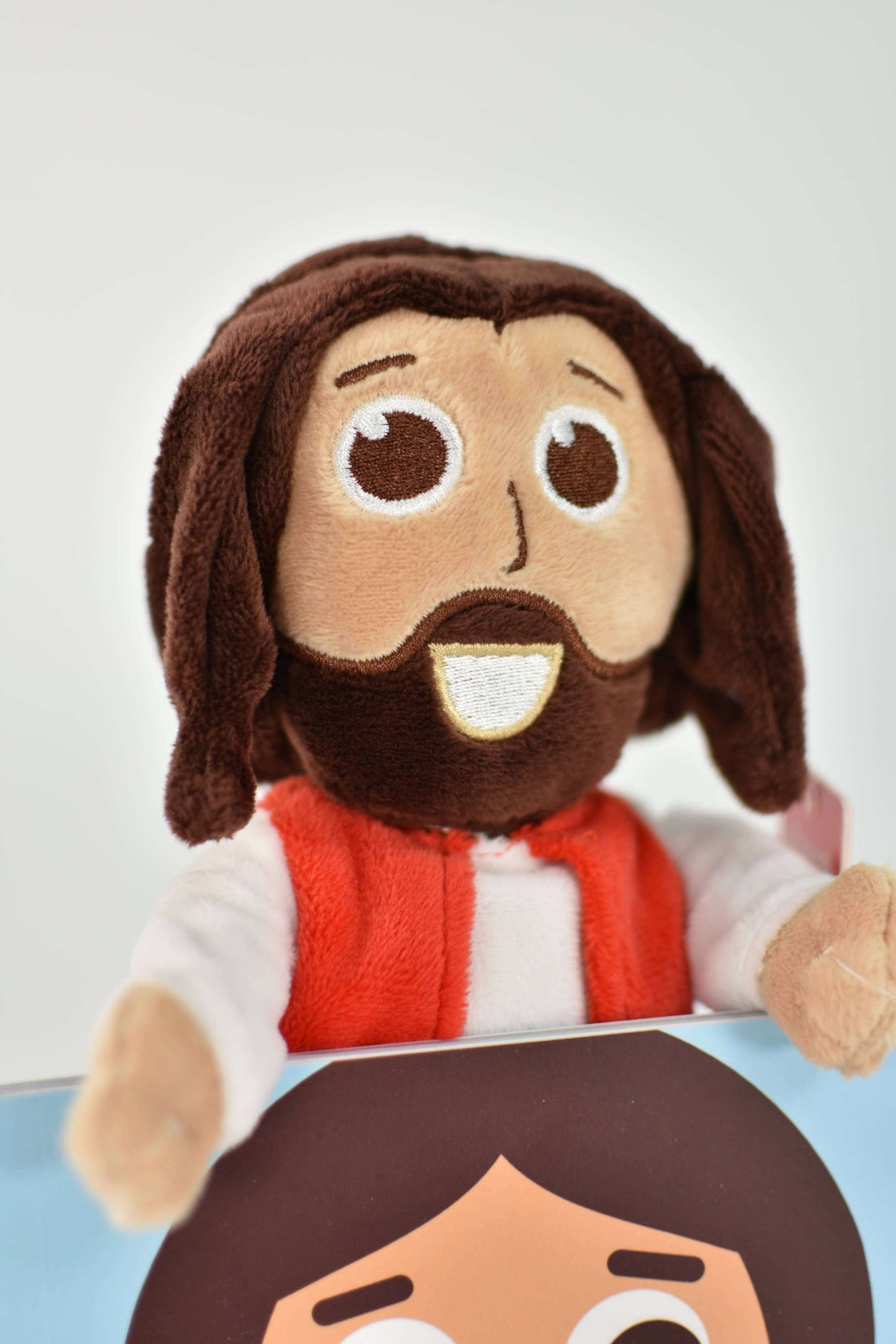 Cuddly Jesus doll with brown hair and smiling face, part of the Jesus Doll & Book Bundle for kids.