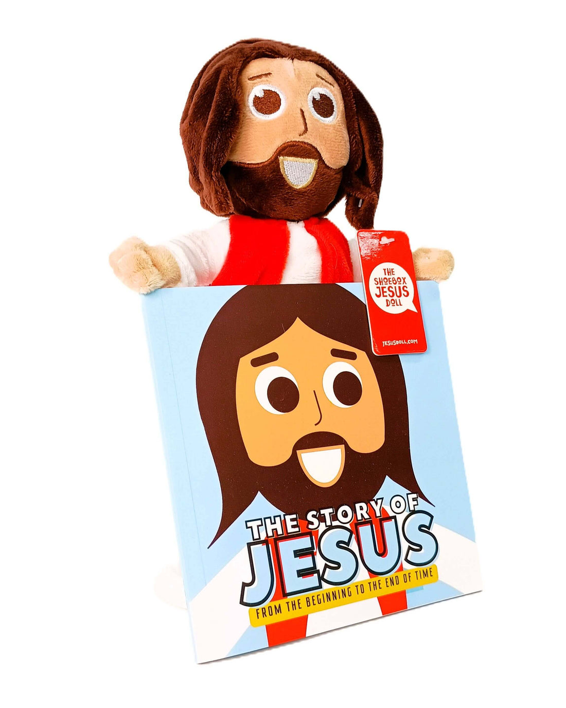 Cuddly Jesus doll with happy expression next to children's book 'The Story of Jesus' for faith-based fun.