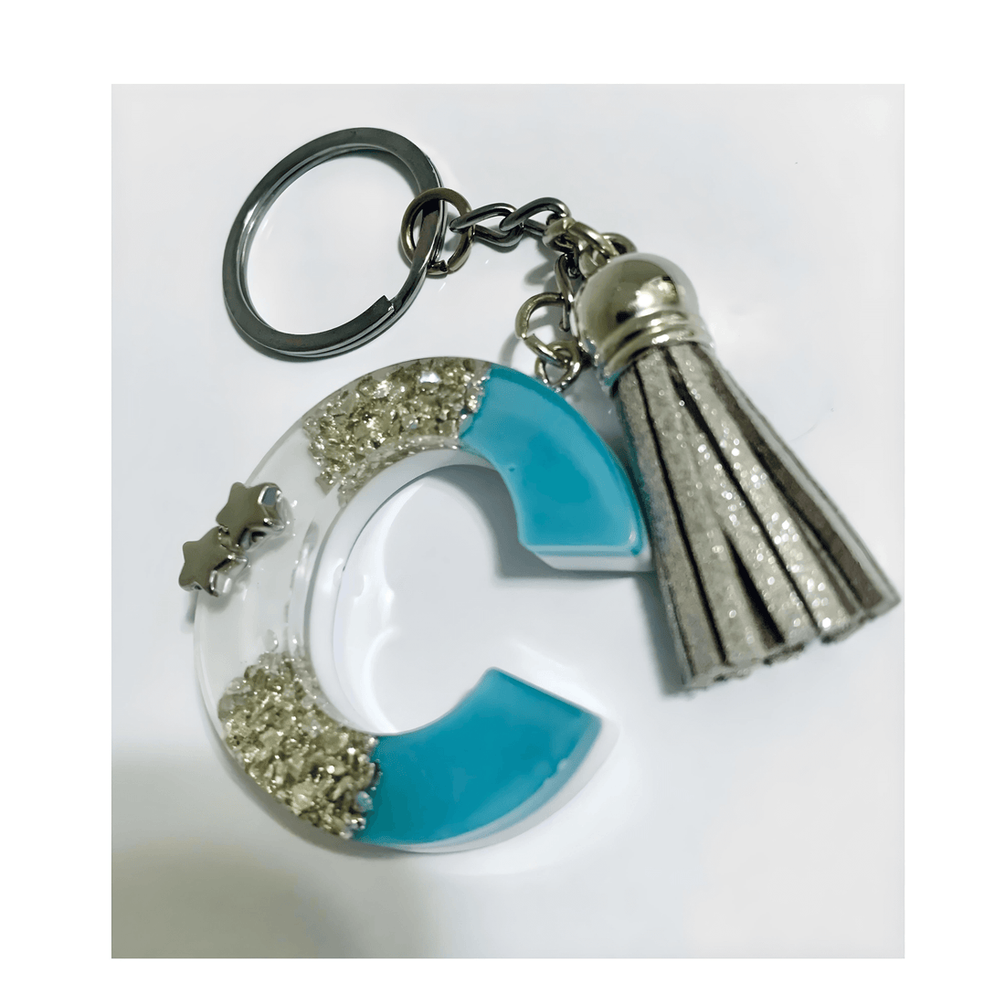 Letter C Resin Keychain – Blue & White Marbled Charm with silver tassel and star embellishments.
