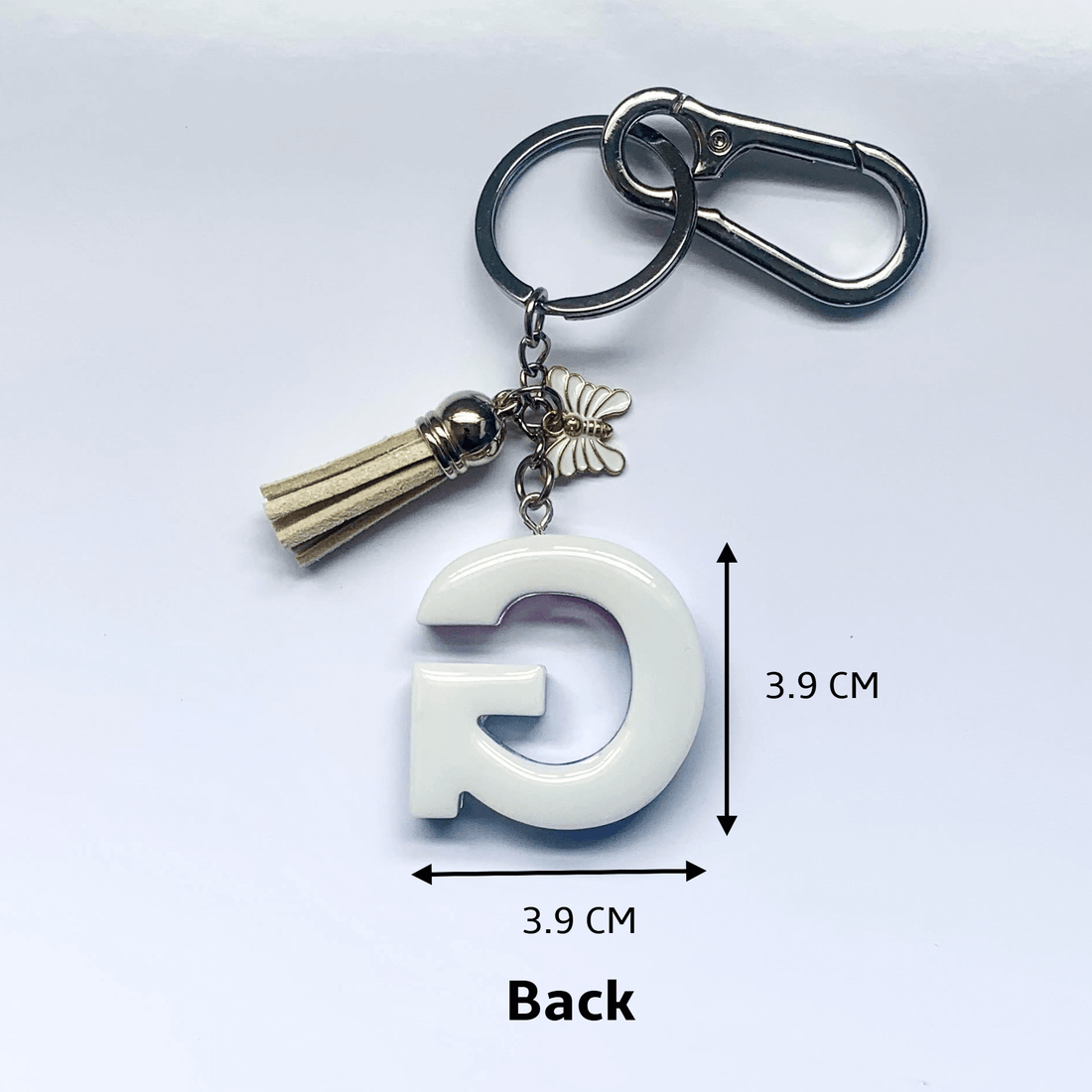 Letter G Keychain with Carabiner – Glitter & Tassel Charm featuring a tassel and butterfly embellishment.