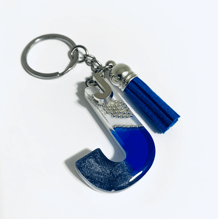 Letter J Resin Keychain – White & Blue Marbled Charm showcasing elegant marbled design and tassel accessory.