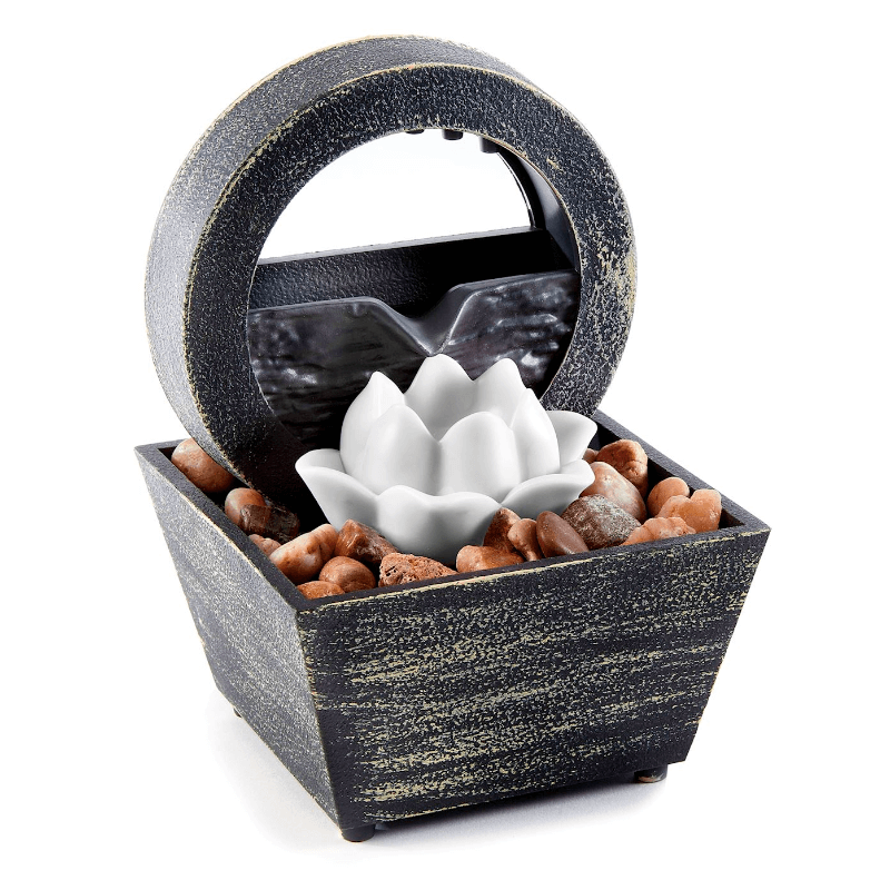 Lotus table fountain with LED light, unique design, cascading water, and decorative stones for serenity.