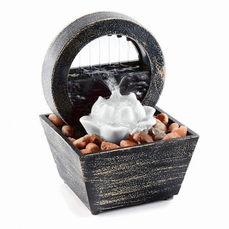 Lotus table fountain with LED light and decorative stones, creating a tranquil water feature for relaxation.