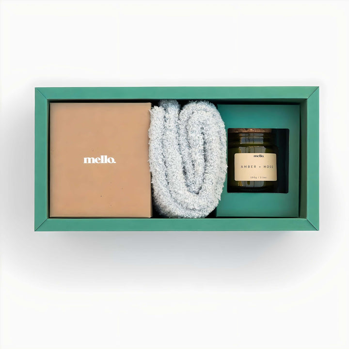 Mello Max Relax gift set featuring soft blanket, candle, and elegant packaging for relaxation and indulgence.