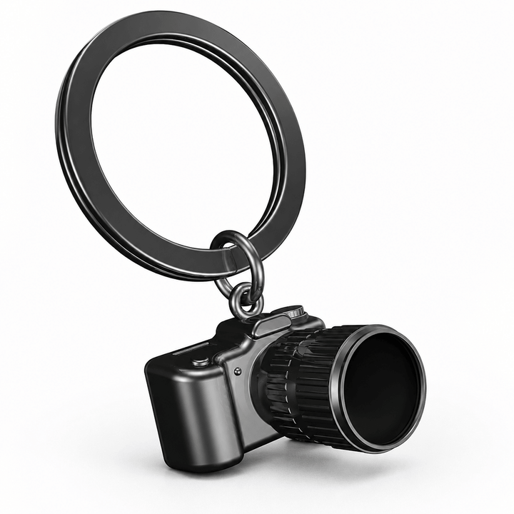 Metalmorphose Camera Keychain in dark gunmetal with detailed camera body, black lens, and circular key ring.