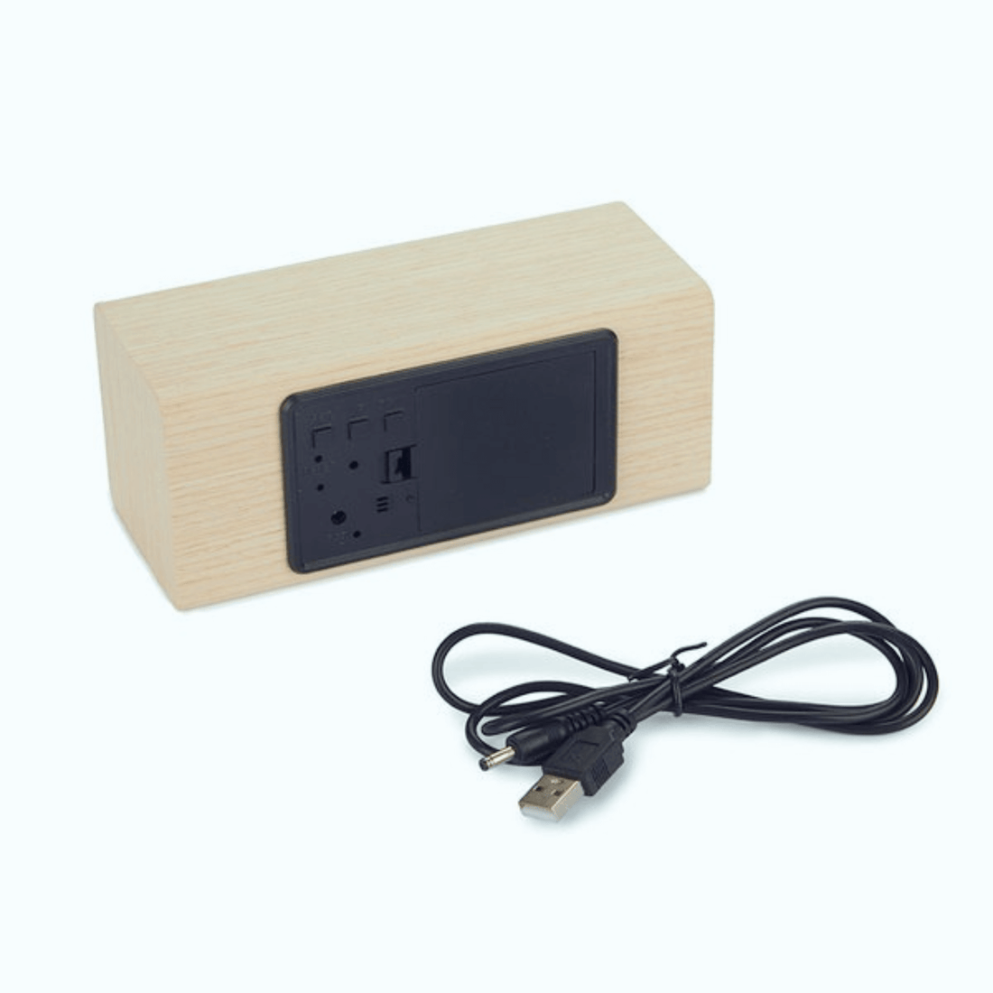 Minimalist wooden LED alarm clock with USB cable, showcasing its sleek cube design and functional back panel.