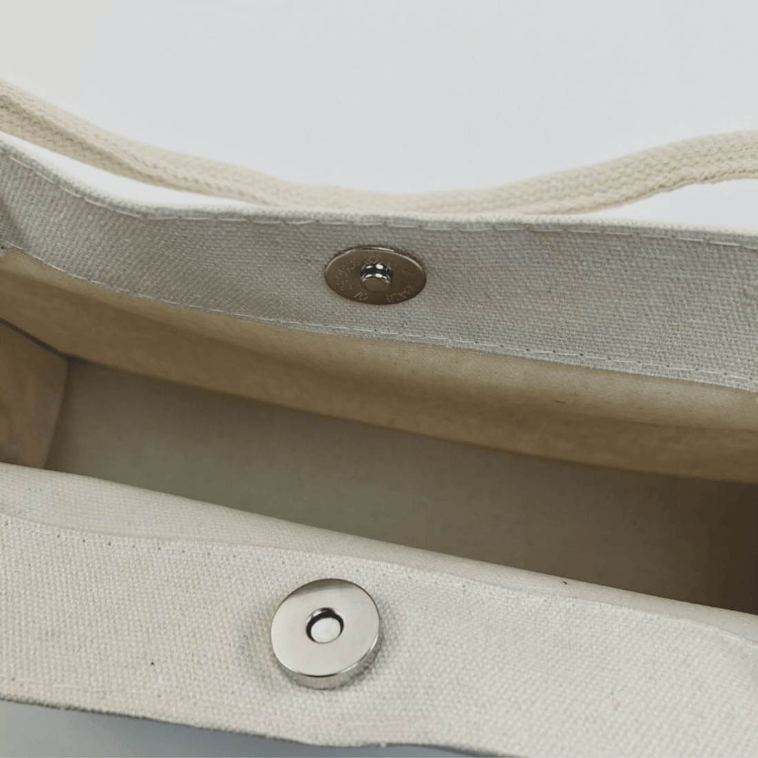Interior view of the Oil Painting Canvas Tote Bag showing its snap button closure and spacious design.