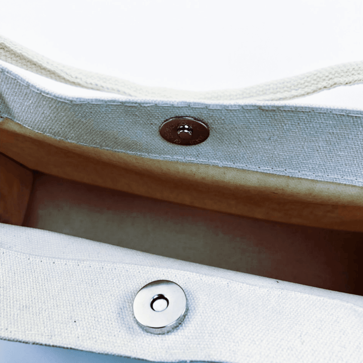 Interior view of the Oil Painting Canvas Tote Bag featuring a snap closure and stylish lining.