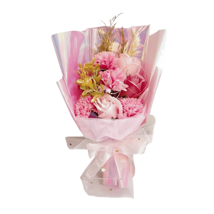 Elegant pink flower bouquet wrapped in soft pastel colors, featuring decorative greenery and delicate petals.