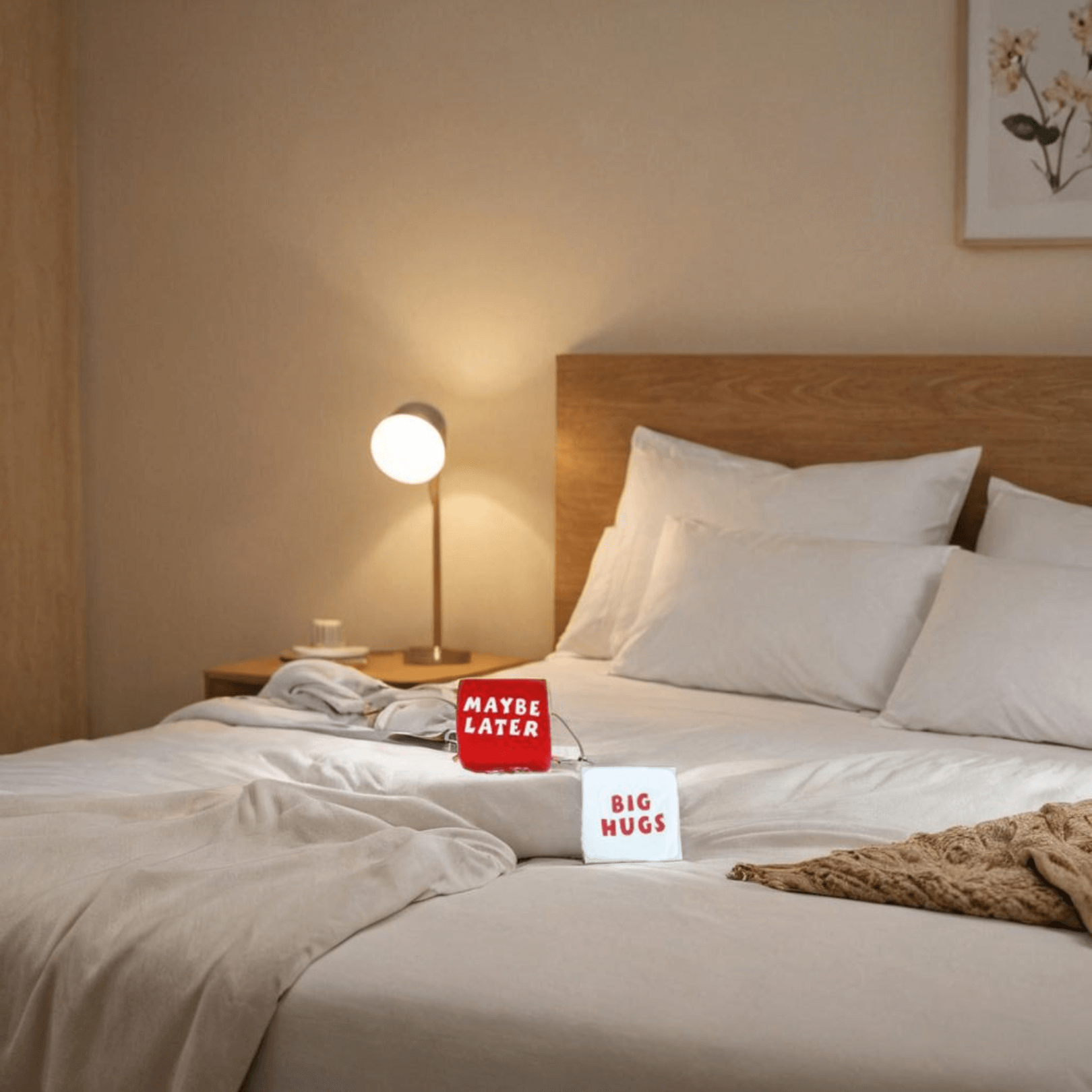 Plush Love Dice - Set of 2 displayed on a neatly made bed with soft blankets and pillows.